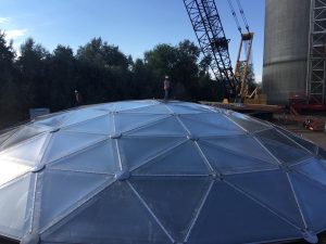 Installer on top of a geodesic dome in Texas