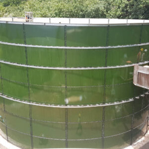 Green Glass Fused to Steel Tank in Pago Pago with installers in a bucket and forest behind.