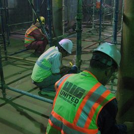 Three workers installing internal supports