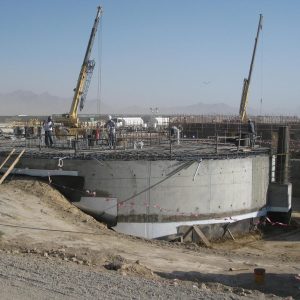 Workers installing forms for a welded storage tank