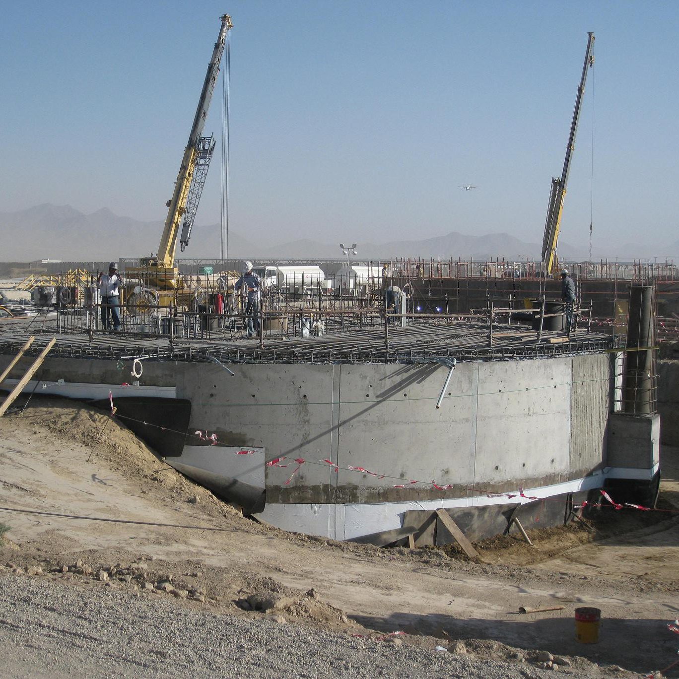 Workers installing forms for a welded storage tank